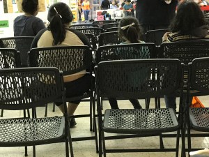 Migrants adorn their hair with strips of tinfoil blankets from detention